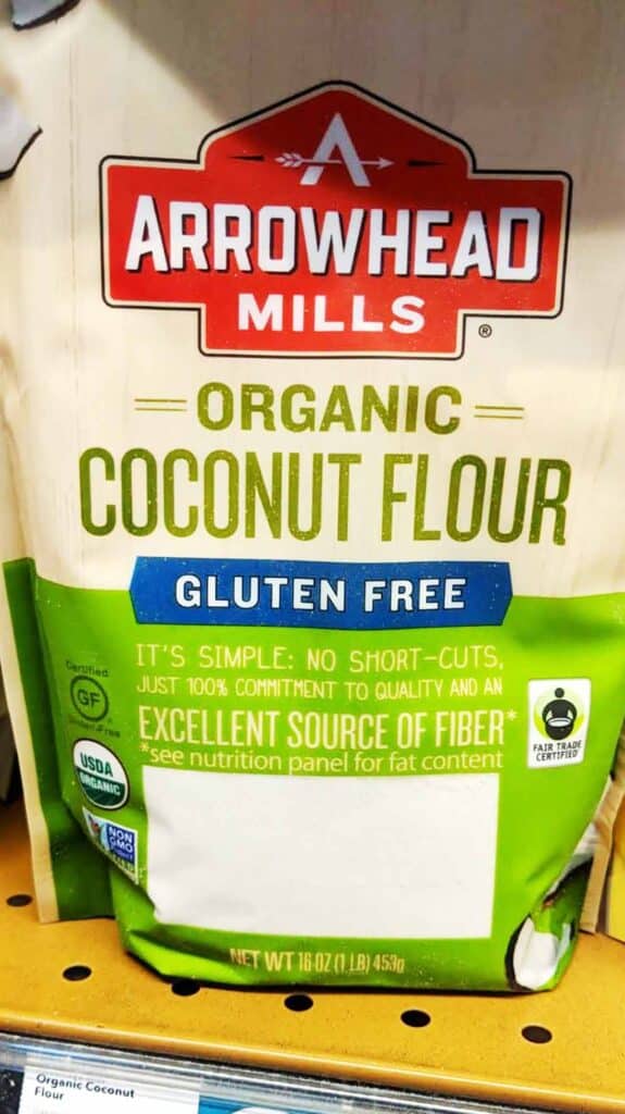 Grocery store shelf with package of coconut flour. 
