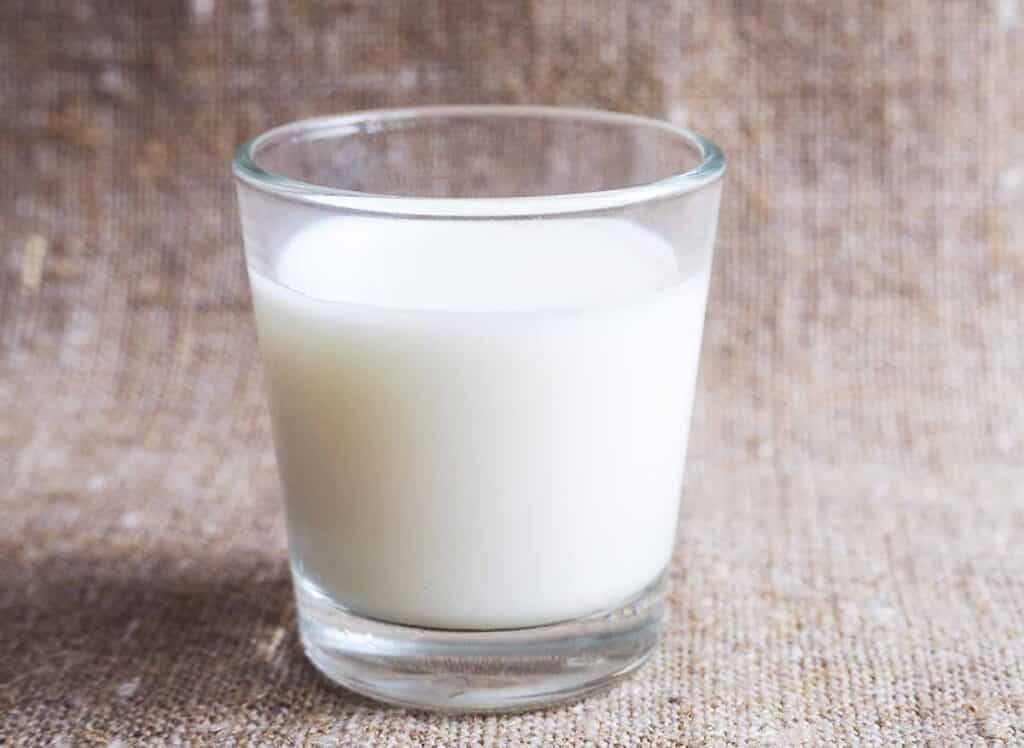 Glass filled with whole milk with light cream