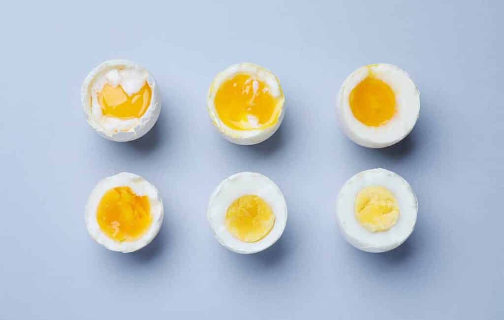 Visual answer with images of boiled eggs at different temperatures.
