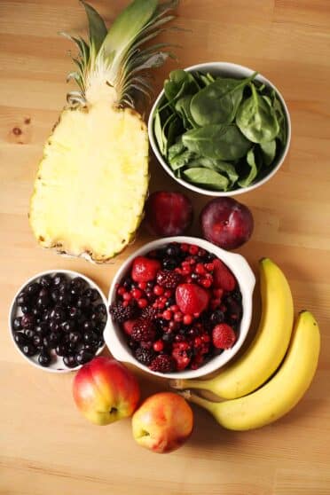 Tabletop with different ingredients to make smoothie.