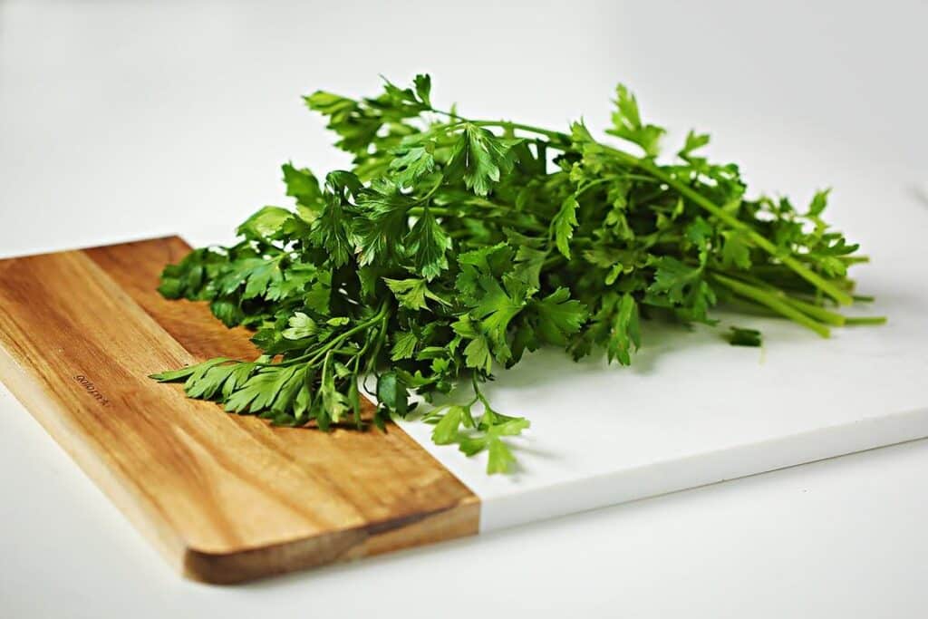 Fresh parsley on top of the marble cutting board. 