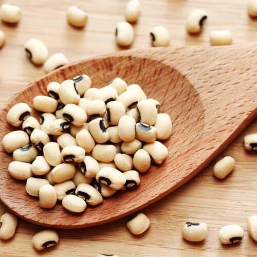 Wooden scoop filled with black eyed peas