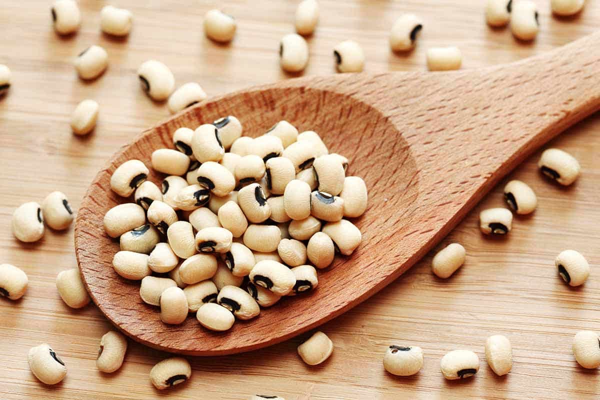 Wooden scoop filled with black eyed peas