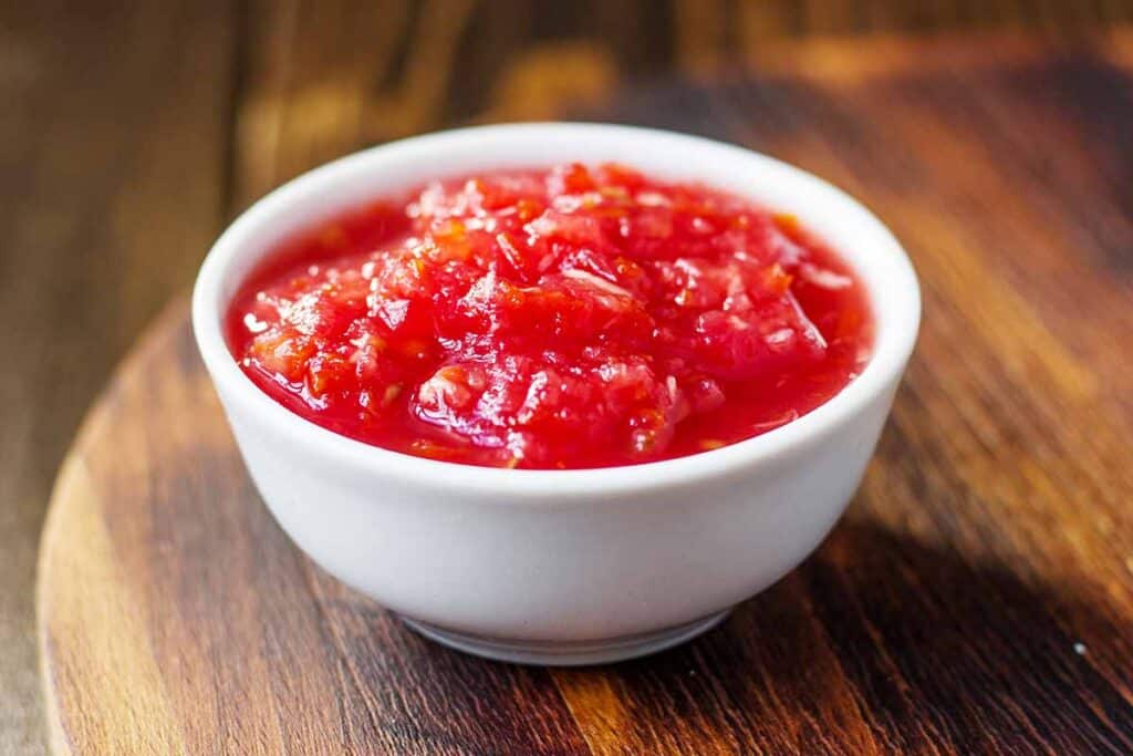 White bowl with canned tomatoes. 