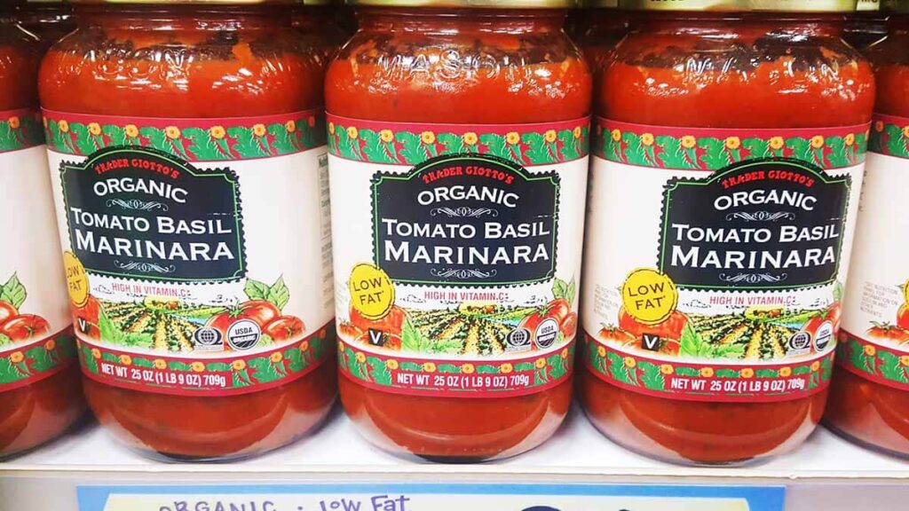 Jars with marinara sauce on the grocery shelf. 