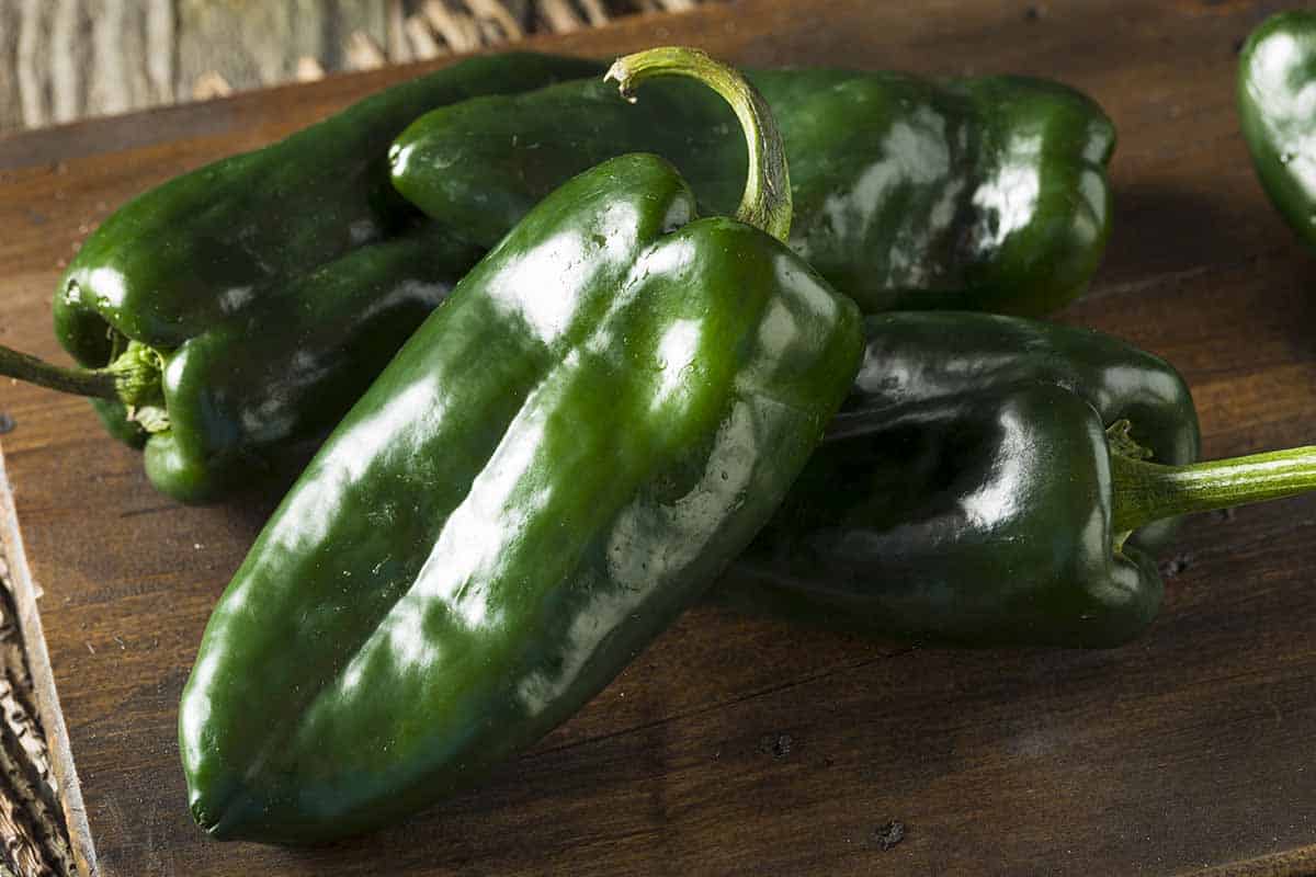 Wooden board with poblano peppers