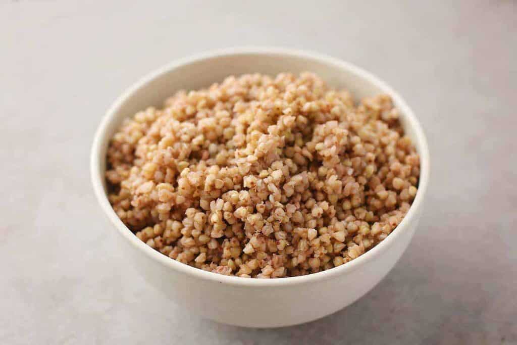 White bowl with cooked buckwheat. 