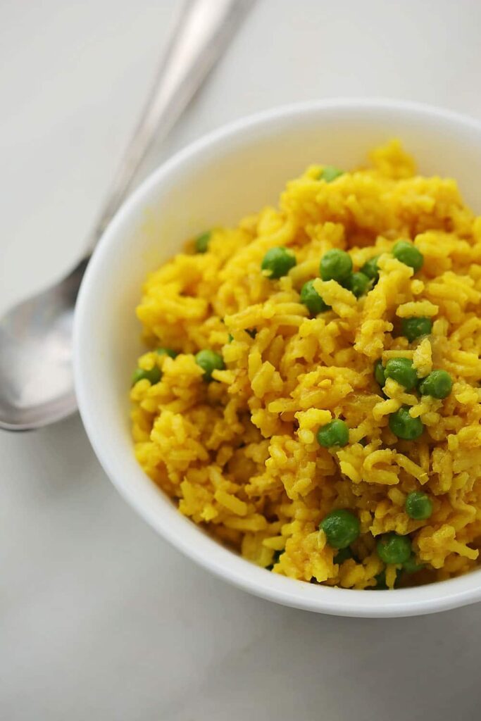 White bowl filled with turmeric chicken rice